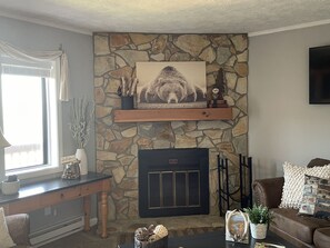 Fireplace with electric log insert. 