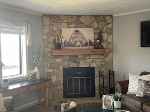 Fireplace with electric log insert. 