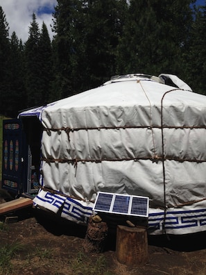 Southward view of yurt with solar panels for charging station.