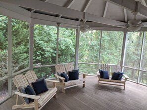 Large attached screen porch with multiple seating options