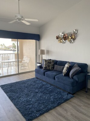 queen size sleeper sofa in living room, also next to balcony and full water view