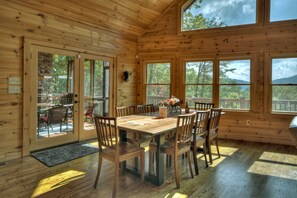 French doors open to screened in porch with wood burning fireplace. 




