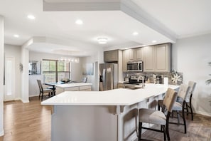 Full Kitchen with Extra Bar Seating and Dining Area