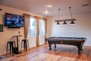 Endless opportunities at the Highlands House. Play pool or ping pong while watching our  55" smart TV. The TV is on an adjustable wall mount that can be viewed from the kitchen while cooking or angled to view while playing games or eating dinner at the dining  table too.