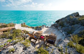 The chairs by the ocean offer a perfect spot to enjoy the many shades of blue of the Caicos Banks.