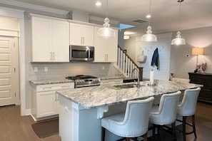 Huge open kitchen with modern gas appliances and everything you need to prepare a gourmet meal and entertain around the kitchen.