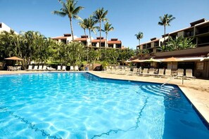 Dive into our sparkling pool surrounded by lush greenery for the ultimate tropical retreat!