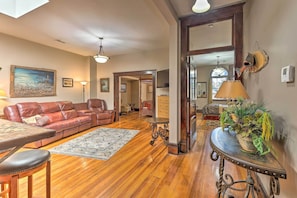 The apartment features homey touches like hardwood floors and a plush sofa.