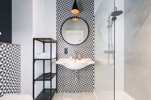 Bathroom with washing machine and towels.