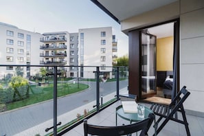 Spacious balcony with outdoor furniture.