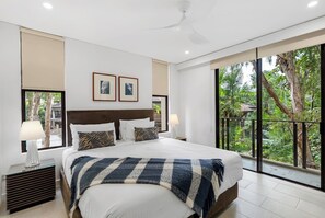 Drift into deep sleep in the king-size bed of the primary suite, where soft tones and expansive windows create a calming retreat.