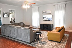 The smaller couch converts into a queen-size bed