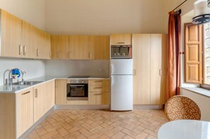 A compact and functional kitchen space, equipped for culinary exploits in a homey setting.