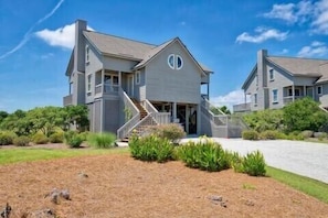 Front of house. Street side. Carport plus driveway that fits at least 3 cars.