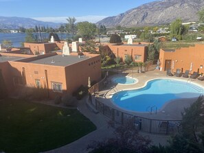 view of pool and lake from deck