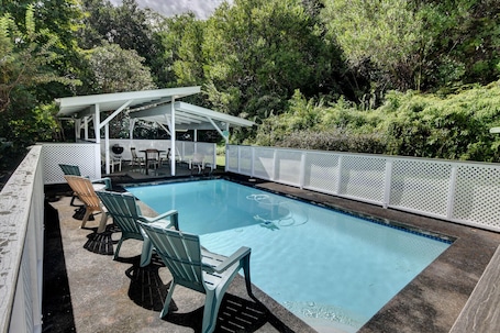 Very private backyard pool w/ covered shelter, dining table and charcoal grill.