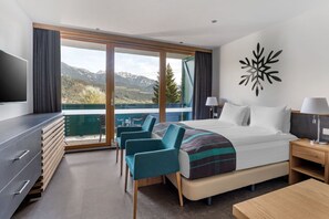 A room with a view and comfortable furnishings for a relaxing stay.
