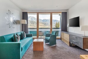Spacious living area with chic turquoise accents.