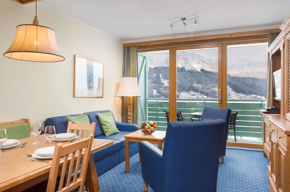 A welcoming dining and living space with picturesque window views.