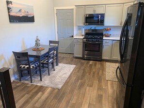 View of kitchen area from front door entrance