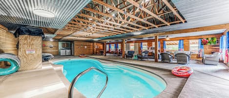 Indoor pool area with living room and kitchen