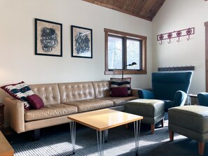 An 8-foot leather sofa and lounge chairs make for a cozy and comfortable living room.