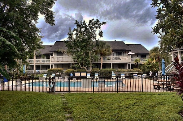 Condominium pool with back view of units