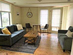 The living room features an eat-in dining space plus living space, a flat-screen TV, and in-unit laundry.