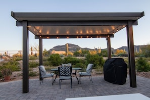 Relax and enjoy the views under the pergola while grilling your meals