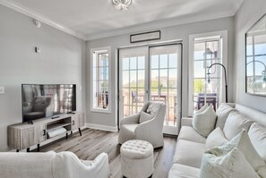 Light and airy family room next to sliding doors and balcony that overlooks 30A