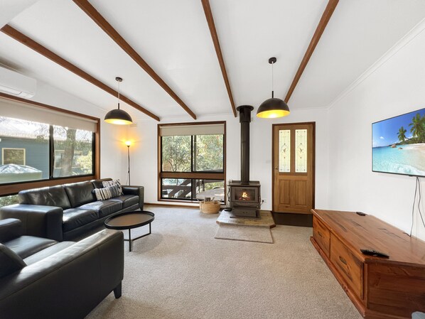 Perfect living room: leather sofas, wood fire, Smart TV.