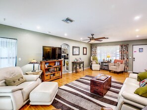 Main living room. Hardwood floors, view of front yard and pool out back. 