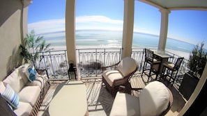 Second floor balcony with luxury furniture and plants.