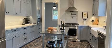 Chef’s Kitchen , five-burner gas stove, custom cabinets, granite countertops. 