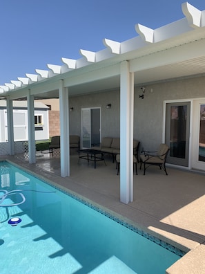 Covered patio area with comfortable furniture