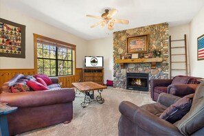 Living Room featuring Cable TV, Sofa Bed and a Seasonal Gas Fireplace