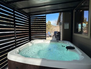 Relax in the hot tub with beautiful views and plenty of seating for outdoor living!