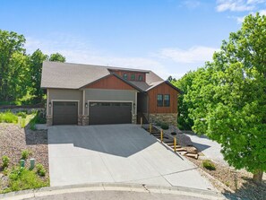 Plenty of parking in driveway, garage, and additional parking pad on the side of the house