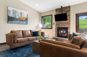 Open Living area with fireplace and views of the backyard