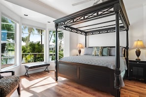 The luxurious master bedroom has all the comforts of home and then some with a California king bed and stunning water views.