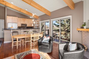 The open concept living area with vaulted ceilings and wall to wall windows is an inviting space to relax.