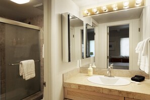 The bathroom in the second bedroom offers a separate vanity area and a bathtub and shower.