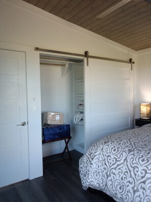 Barn door closet, with full length mirror, extra pillows, bedding, iron. 