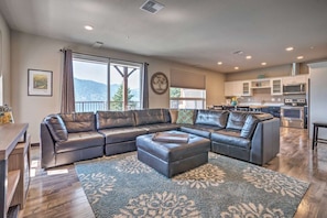 Spacious living room leading to deck with views