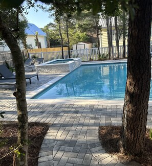 Serene garden environment surrounds the backyard pool