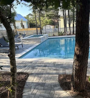 Serene garden environment surrounds the backyard pool