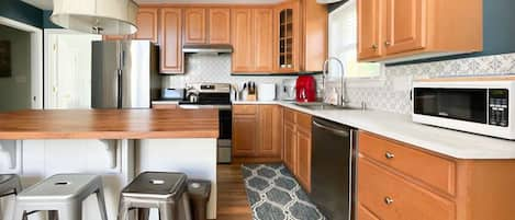 Sunny and bright, large well equipped kitchen with island