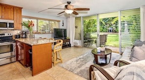 Living room with cherry kitchen with granite countertops 