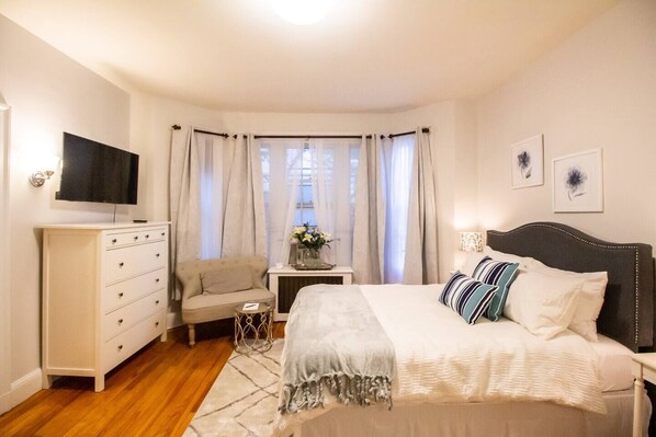 TV Mounted to wall for easy viewing from bed or high top dining table