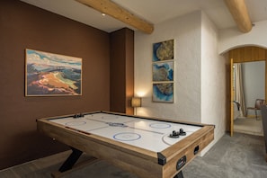 Recreation Room Bliss:
Challenge friends to an air hockey match in the versatile rec room, filled with games and fun for all ages.